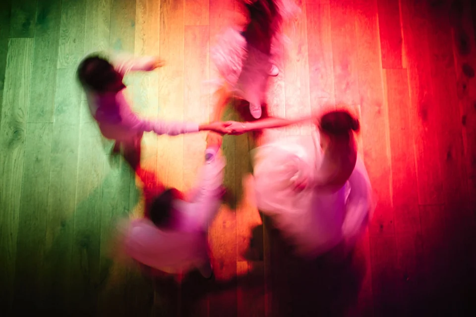 Wedding guests dancing in colourful light at Kimberley Hall