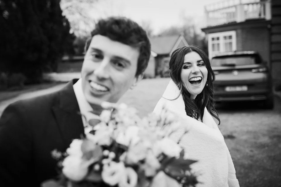 A laughing couple outside The Norfolk Mead, photographed in black and white