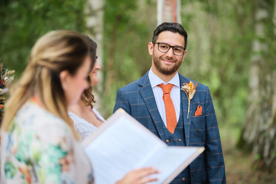 The groom looking towards the bride during the ceremony