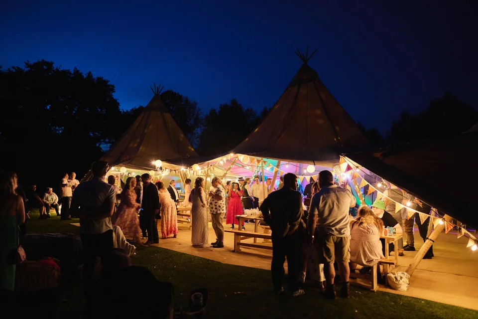 The wedding tipi lit up after dark