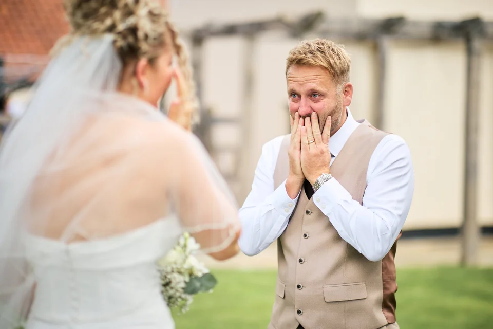 The groom reacting as the bride arrives