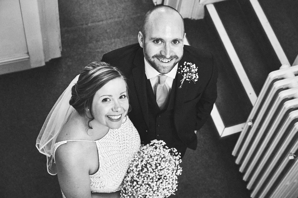 Hayley and Adam smiling together on the staircase at The Georgian Townhouse